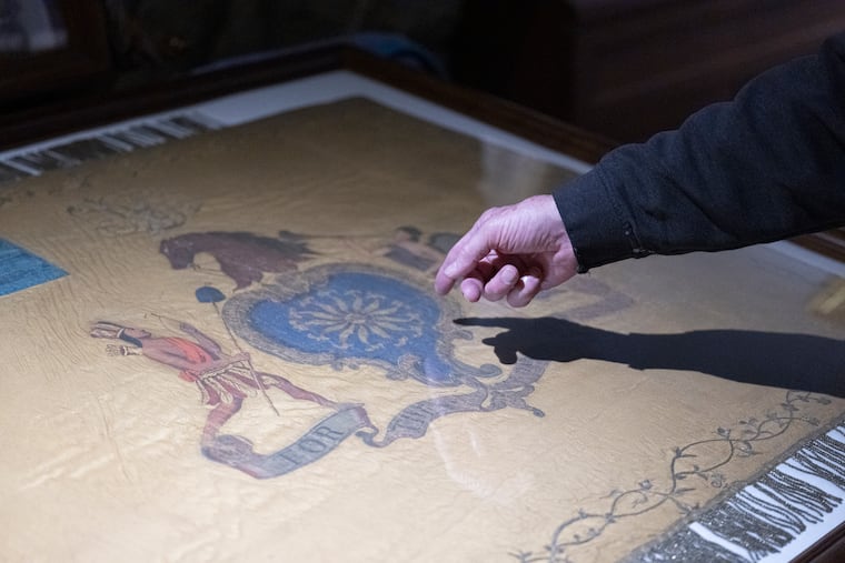 Dennis Boylan, former commander of the First City Troop, shows a replica of Philly's famed Revolutionary War flag at the 23rd Street Armory in Philadelphia, on Friday, May 23, 2025. The original flag is on loan for an exhibit at the Museum of the American Revolution in Philadelphia.