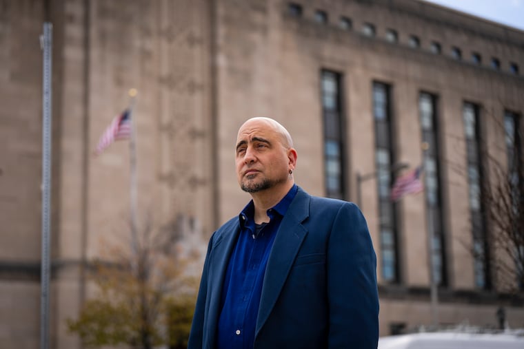 IRS union representative Alex Jay Berman, in front of the IRS building at 30th and Market Streets, in Philadelphia in April. Berman has been helping probationary IRS employees navigate their return to work after hundreds were fired in February, then reinstated later.