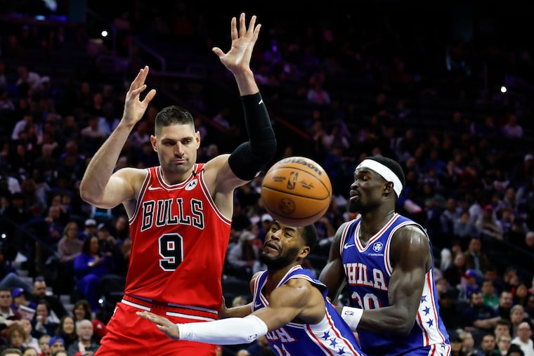 Bulls center Nikola Vucevic loses the basketball against Sixers guard Jared Butler with center Adem Bona in the second quarter.
