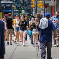 Pedestrians ambling in Center City on Tuesday as temperatures climb and veils of smoke fill the air. It's going to get steamier Wednesday.