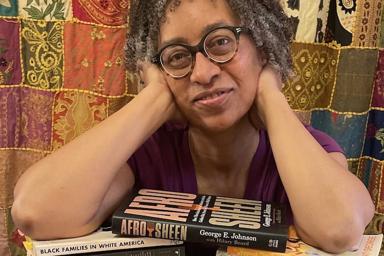 "Afro Sheen" author Hilary Beard with the 16 books she read to research the story of George  E. Johnson, founder of Afro Sheen.