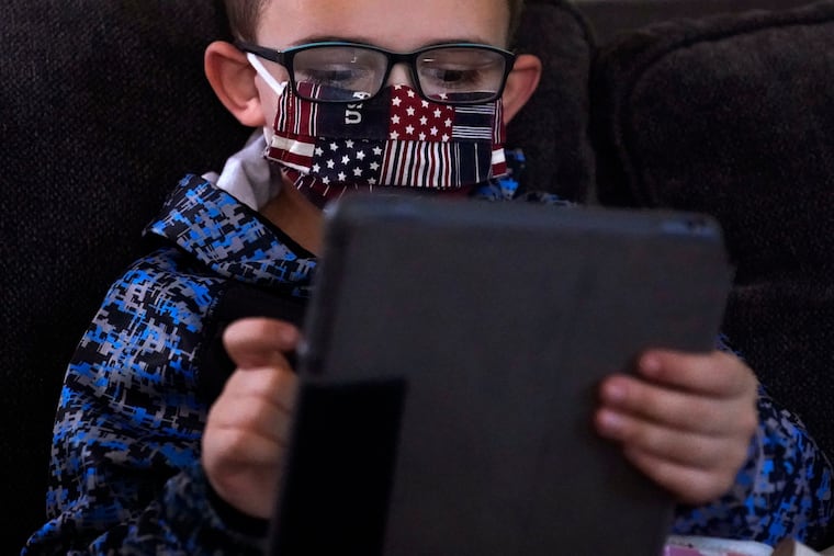 A kindergartener takes part in distance learning in Massachusetts during the COVID-19 outbreak in October 2020. Threats to funding of public broadcasters increses the difficulty of planning for the next education crisis, writes Yoni Greenbaum. 