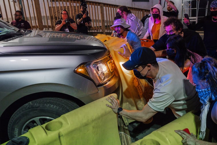 Protesters attempt to block a vehicle from leaving the Delaney Hall Detention Facility during protests over federal immigration enforcement raids on Thursday, June 12, 2025, in Newark, N.J.