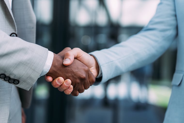 In this stock photo, two people shake hands in a business deal. One popular option for small-business owners looking toward retirement is to sell a business to a private equity firm.