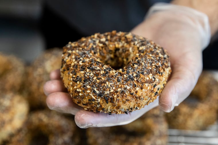 Jacob Cohen of Kismet Bagels holds an everything bagel in their new bakery in the MaKen Studios North building in Philadelphia, Pa. on Thursday, November 5, 2020.