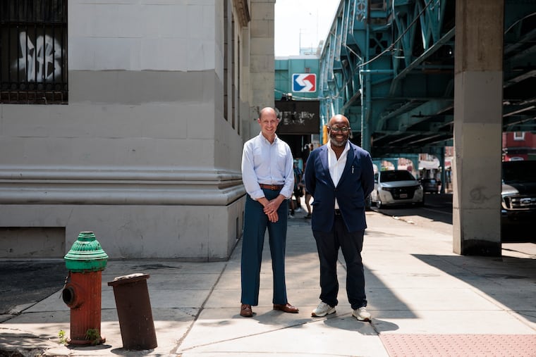 Tayyib Smith and Jacob Roller outside of the historic bank they plan to turn into a base for Black-owned businesses and market rate apartments, near the Huntingdon El station in Philadelphia.