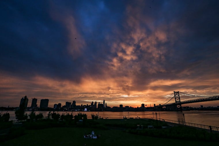 The summer solstice sun sets on Philadelphia as scene from the Camden waterfront in June 2022. The solstice arrives this year at 10:42 p.m. Friday.