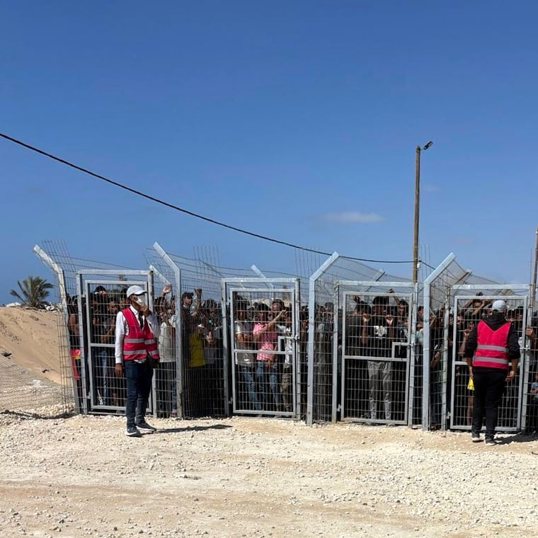 This photo, provided by an American contractor on condition of anonymity, shows Palestinians behind gates before entering a food distribution site operated by the Gaza Humanitarian Foundation in May 2025, shortly after the start of the organization's distribution sites.