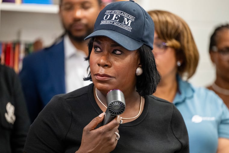 Mayor Cherelle L. Parker fans herself as other members of her leadership team speak as she briefs the news media at the Tustin Playground at 60th St. and W Columbia Ave. Tuesday, Jul, 1, 2025, on the first day of the strike by District Council 33.