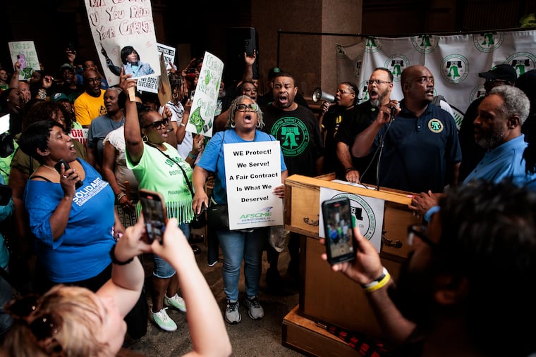 Rally attendees chant during a AFSCME District Council 33 Solidarity Rally at City Hall on Monday.