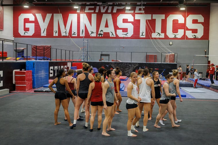The Temple gymnastics team practices in February. Freshman gymnast Emma Reathaford was among those who objected to the House settlement with the help of her mother, an attorney.
