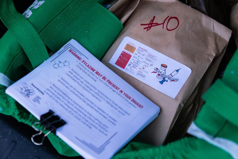 A naloxone kit and fliers about the dangers of xylazine, an animal tranquilizer increasingly mixed with street drugs, given out to drug users.