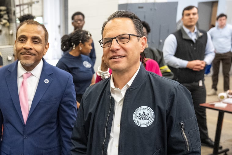 Gov. Josh Shapiro stands with Superintendent Tony B. Watlington during a visit to A. Philip Randolph Career and Technical High School in Philadelphia.