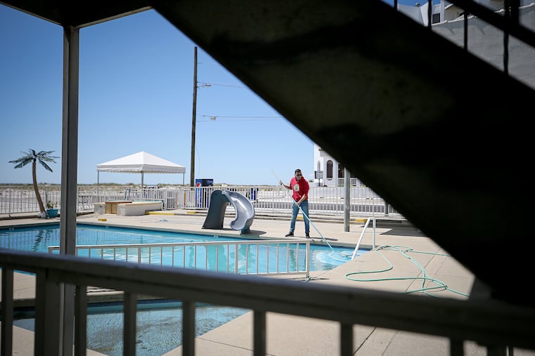 Javier Salinas cleans the pool at the Conca D'or Motel in Wildwood Crest in 2021. If certain hotel amenities are important to you, like a pool, Checkbook recommends reading up on those features before booking.