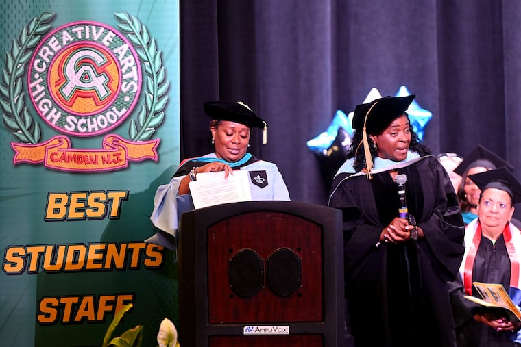 Creative Arts High School principal Davida L. Coe-Brockington (right) and outgoing Superintendent Katrina T. McCombs (left) stand on stage during graduation this week.