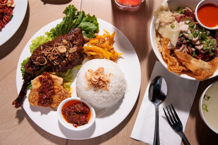 The nasi ayam taliwang (left) and pork U.P. noodle at Indo Spice in Philadelphia. Indo Spice is located at 1421 West Passyunk Ave.