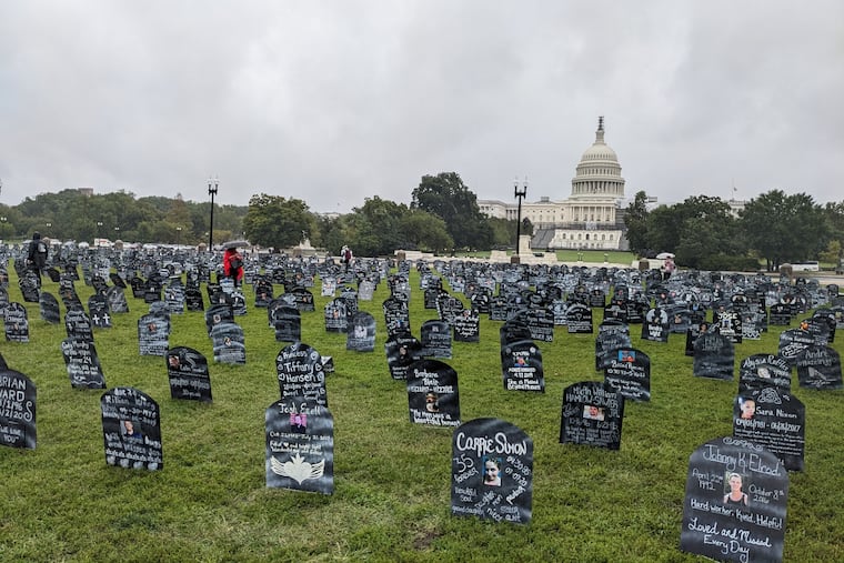 Friends and family who lost loved ones to the overdose crisis placed hundreds of cardboard memorial markers near the U.S. Capitol during a Trail of Truth event on Sept. 23, 2023, calling on lawmakers to take more action to address addiction policies. (Aneri Pattani/KFF Health News)