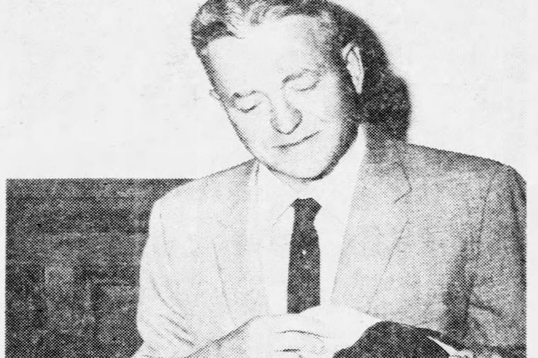 Philadelphia Postmaster Anthony Lambert holds the flag stolen from Betsy Ross' gravesite.