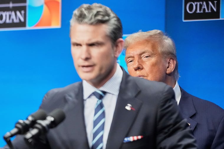 President Donald Trump watches Defense Secretary Pete Hegseth during a news conference after the plenary session at the NATO summit in The Hague, Netherlands, on Wednesday.