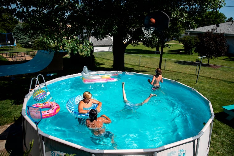 People enjoy a summer day in the pool in Omaha, Neb., in 2020. Lower prices for pool party supplies could be partly due to suppliers ordering too much stock before tariffs kicked in, theorized one economist.