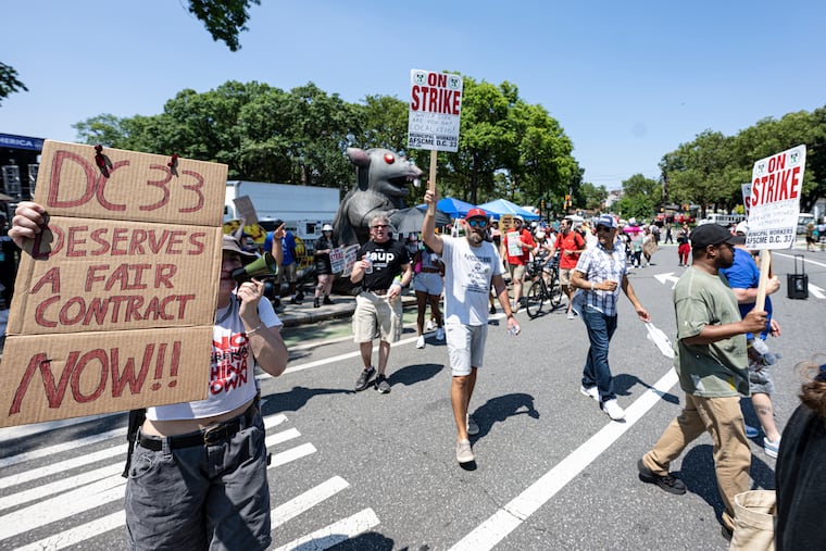 Workers protest on on the Benjamin Franklin Parkway on Thursday.