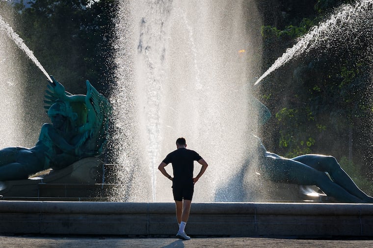 A runner stops at the Logan Circle fountain on the start to a hot day in Philadelphia on Monday.