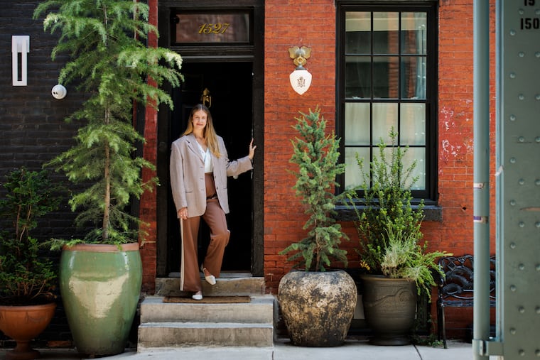 Designer Katherine Lundberg stands in the doorway of Maison Rose in Philadelphia. Lundberg has also worked on a number of local restaurant projects including Suraya and Kalaya.