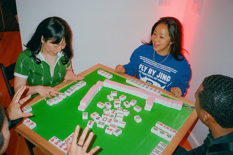 Cathy Rong (left), Questlove's chief of staff, plays mah-jongg with actress Stephanie Hsu. Rong is in charge of planning Questlove's semi-regular celebrity game nights, which have gone viral for their guest lists and attention to detail.