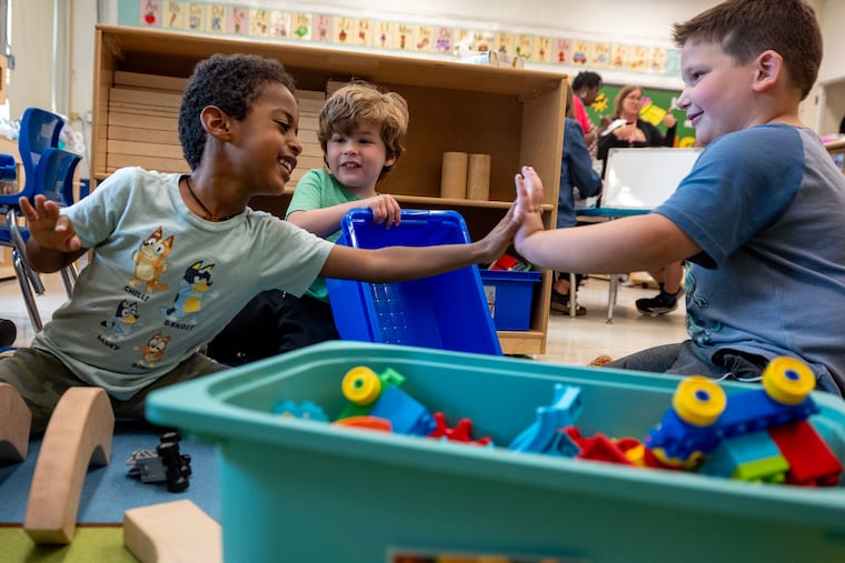 Students give “high fives” while playing in the preschool classroom at the Estelle V. Malberg Early Childhood Center in Cherry Hill this month. Cherry Hill is expanding its preschool program again to offer more seats to 3-year-olds and 4-year-olds. It will take several years for the district to have room for every eligible student with several hundred on the waiting list.