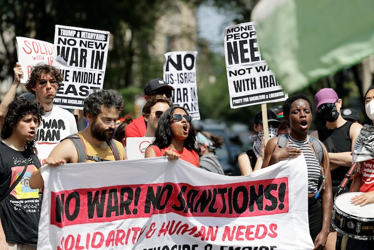 Protesters against the U.S.-Israeli bombing of Iran and the Gaza conflict rally near Rittenhouse Square.