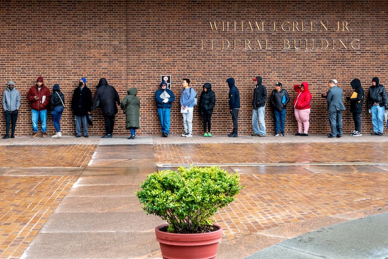 Taxpayers line up outside the William J. Green Jr. Federal Building at Sixth and Arch Streets for free in-person tax preparation and help offered by the Internal Revenue Service in 2023.