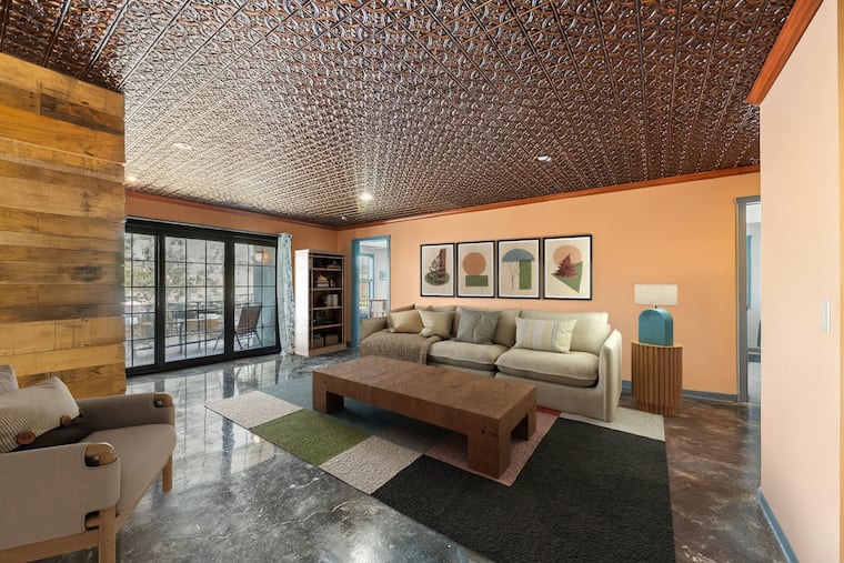 The living room looks out onto a balcony with views of the Manayunk Canal.