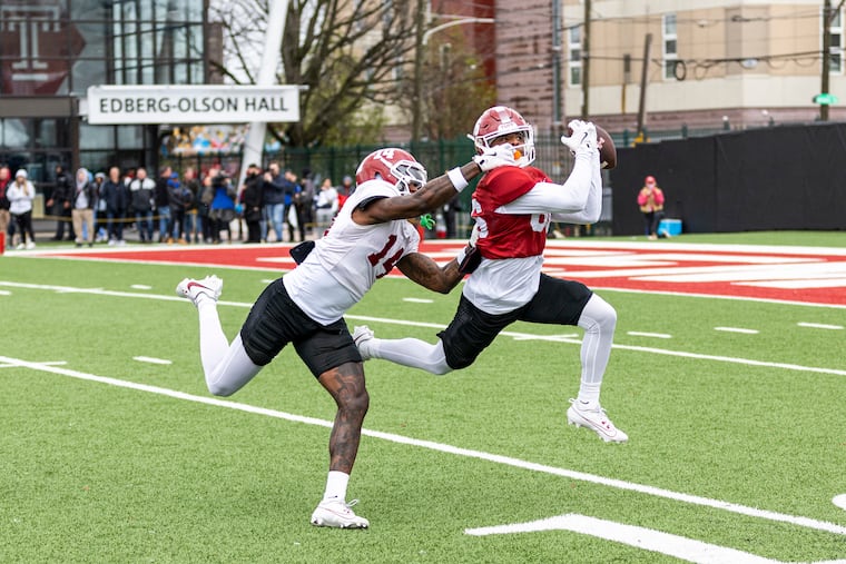 Temple wide receiver Xavier Irvin goes for a catch against teammate Louis Frye during Temple’s Cherry and White game on Saturday.